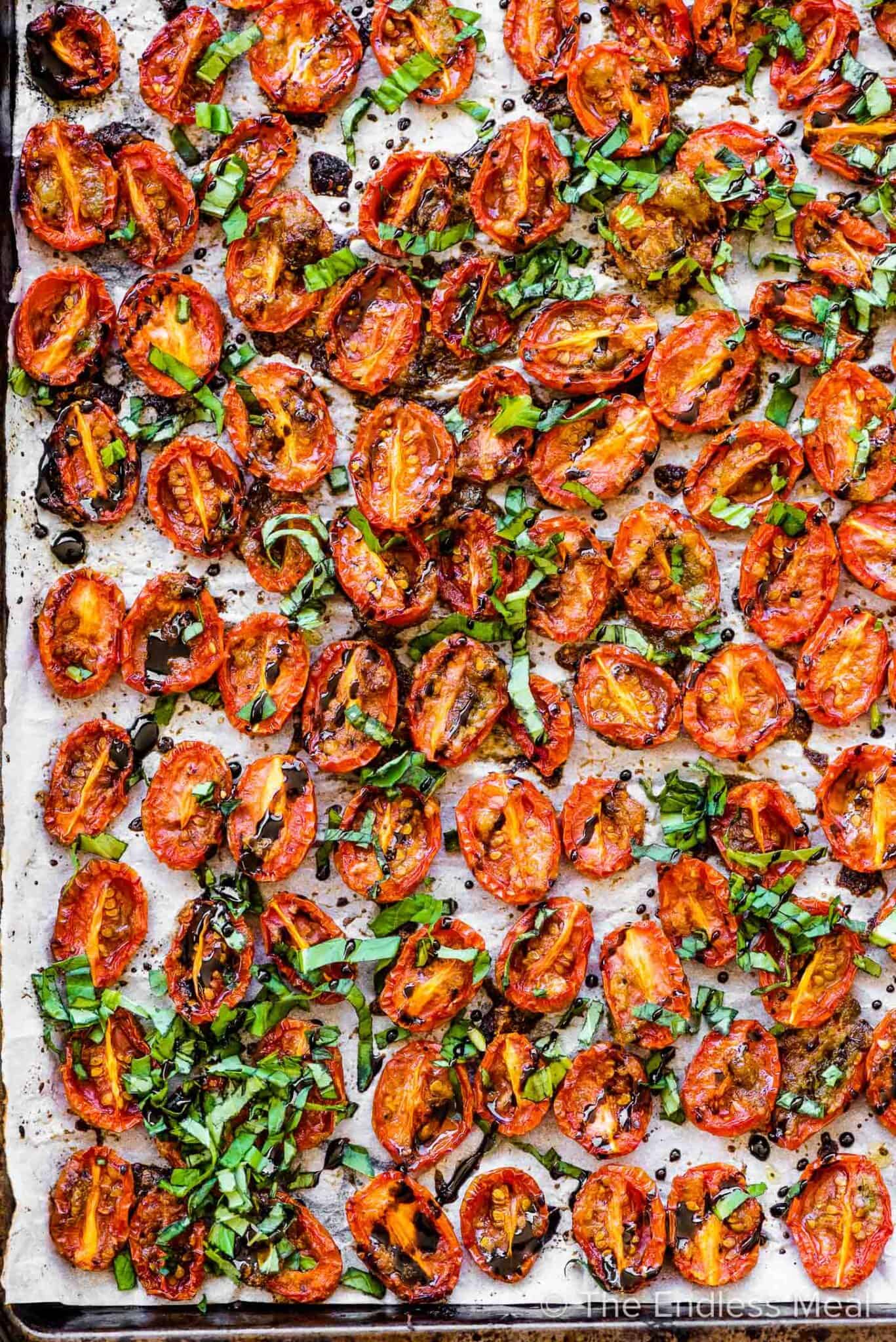 Roasted cherry tomatoes on a baking sheet. 