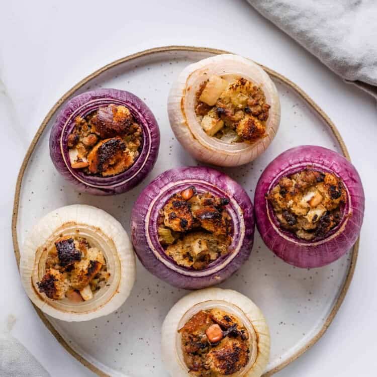 Baked onions stuffed with sausage stuffing on a plate