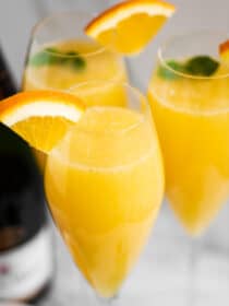 A mimosa garnished with an orange wedge.