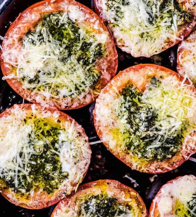 Pesto Stuffed Roasted Tomatoes are a must make side dish/ appetizer. The hollowed out tomato halves are stuffed with an easy to make, garlicky pesto them roasted until the cheese melts and the tomatoes are soft. They're delicious! | vegetarian + gluten-free + keto | #theendlessmeal #tomatoes #pesto #stuffedtomatoes #keto #glutenfree #vegetarian