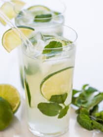 2 mint mojitos garnished with lime.
