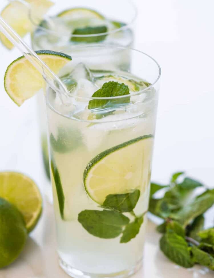 2 mint mojitos garnished with lime.