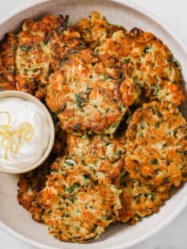 A serving plate with Zucchini Patties and a lemon dip
