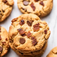 A stack of peanut butter cookies with bacon.