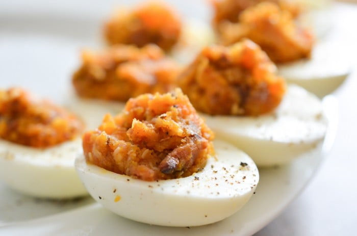 Bacon deviled eggs with caramelized onions and cheddar cheese