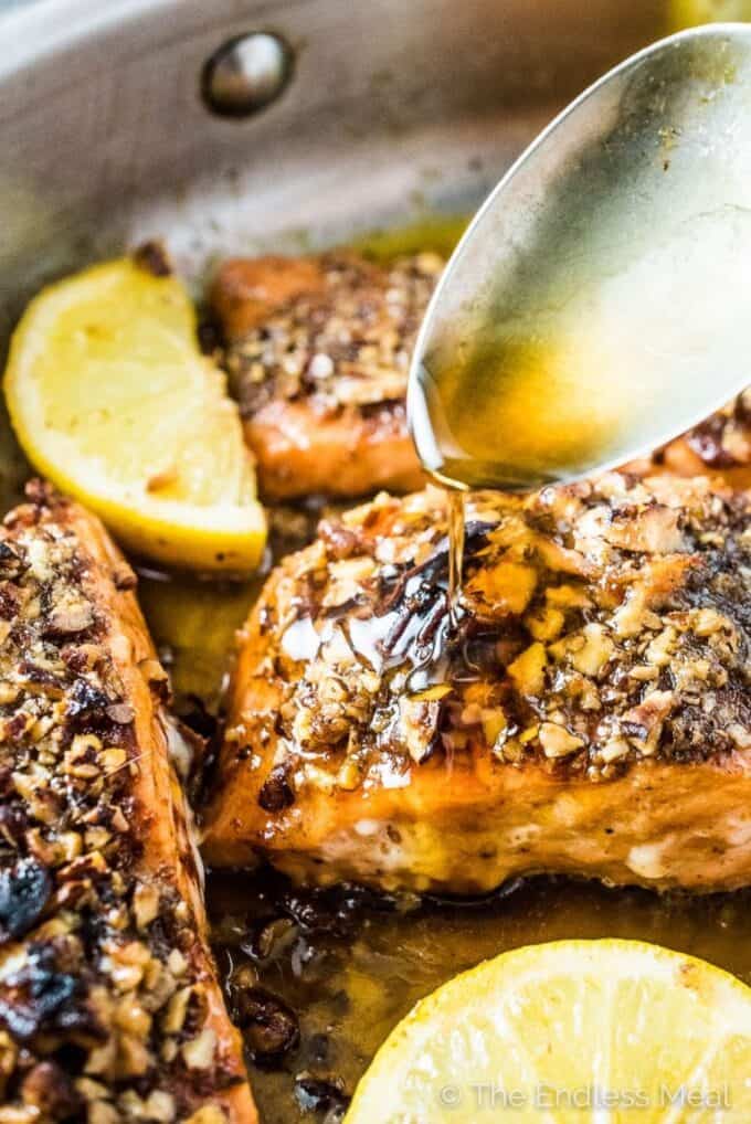 Pecan Crusted Salmon for the win! This super easy and healthy fish recipe will be a hit with everyone at your dinner table. The salmon is seasoned then coated in toasted pecans and cooked in a delicious maple glaze. You will love it! | gluten-free + paleo + dairy-free option | theendlessmeal.com | #salmon #fish #trout #pecans #pecansalmon #glutenfree #paleo #dairyfree #dinnerrecipes #healthydinners