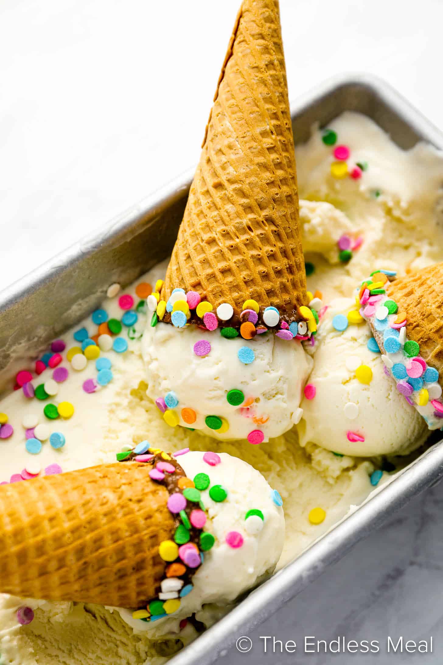 Birthday Cake Ice Cream in a freezer pan with ice cream cones