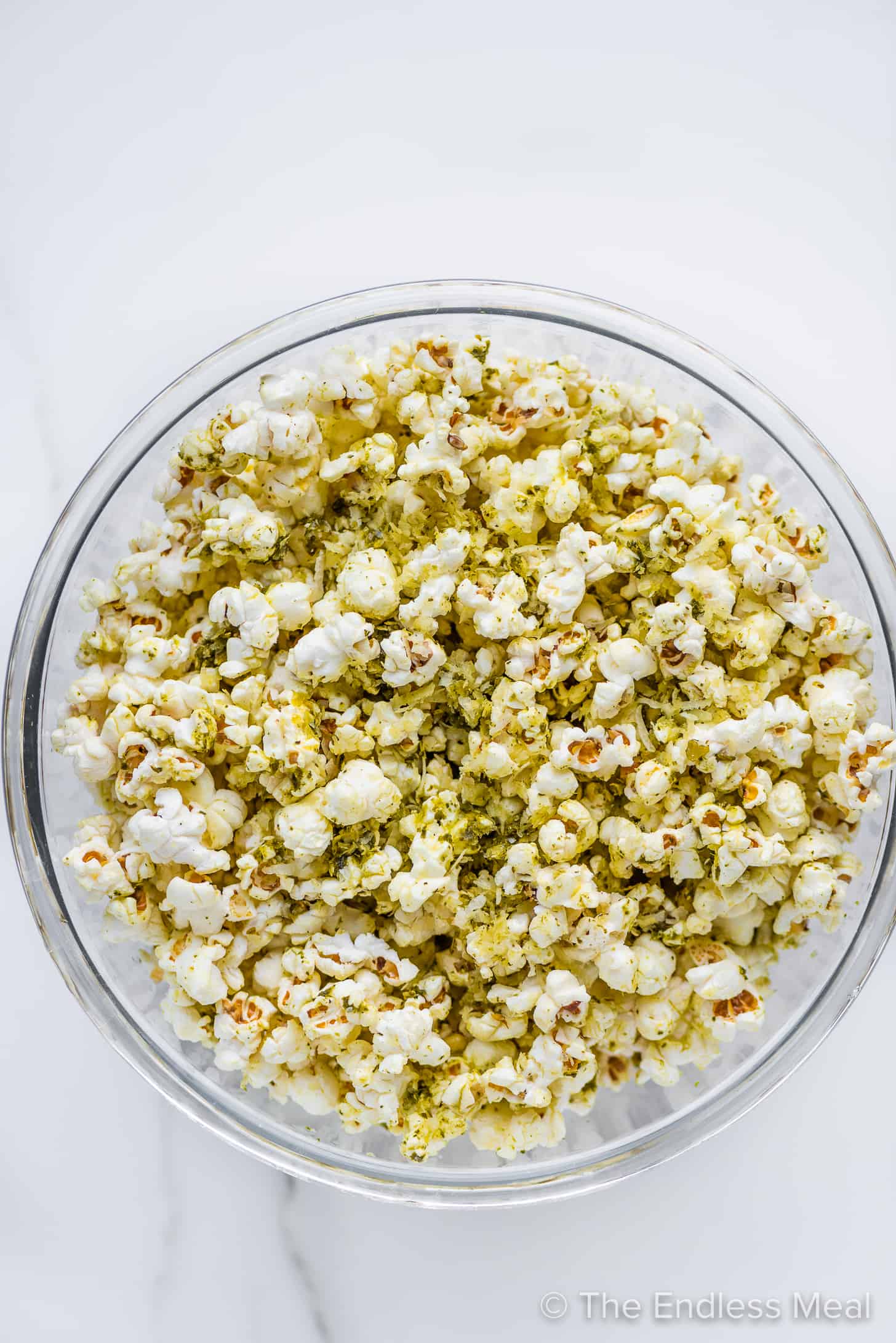 pesto popcorn in a glass serving bowl