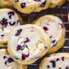 A closeup of a slice and bake white chocolate cranberry cookie.
