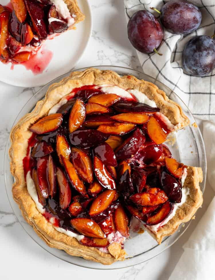 Roasted Plum Pie with a slice missing