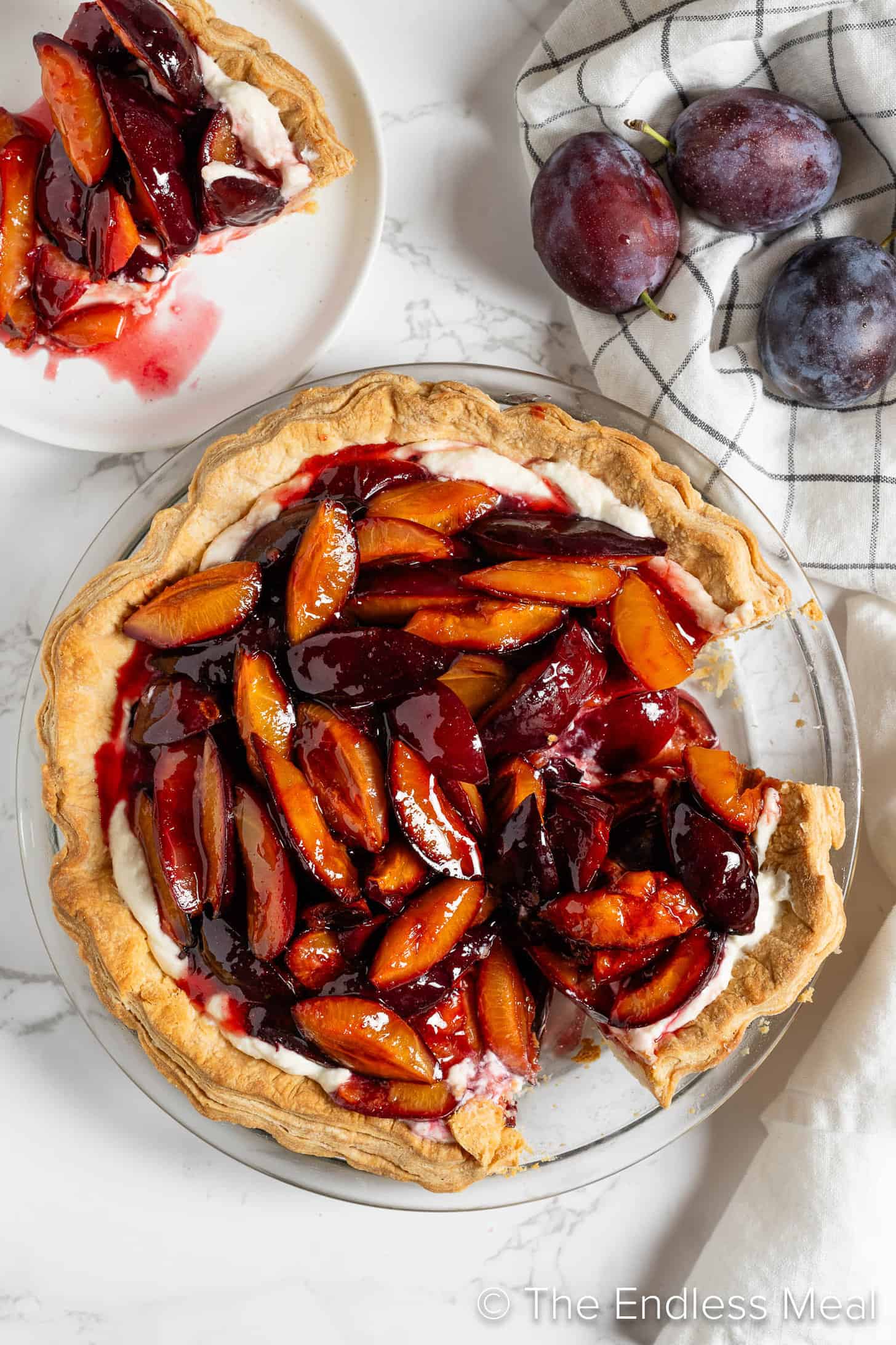 Roasted Plum Pie with a slice missing