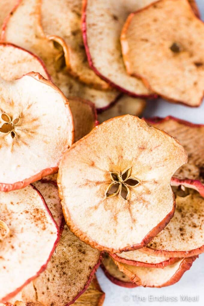 A big pile of baked apple chips.