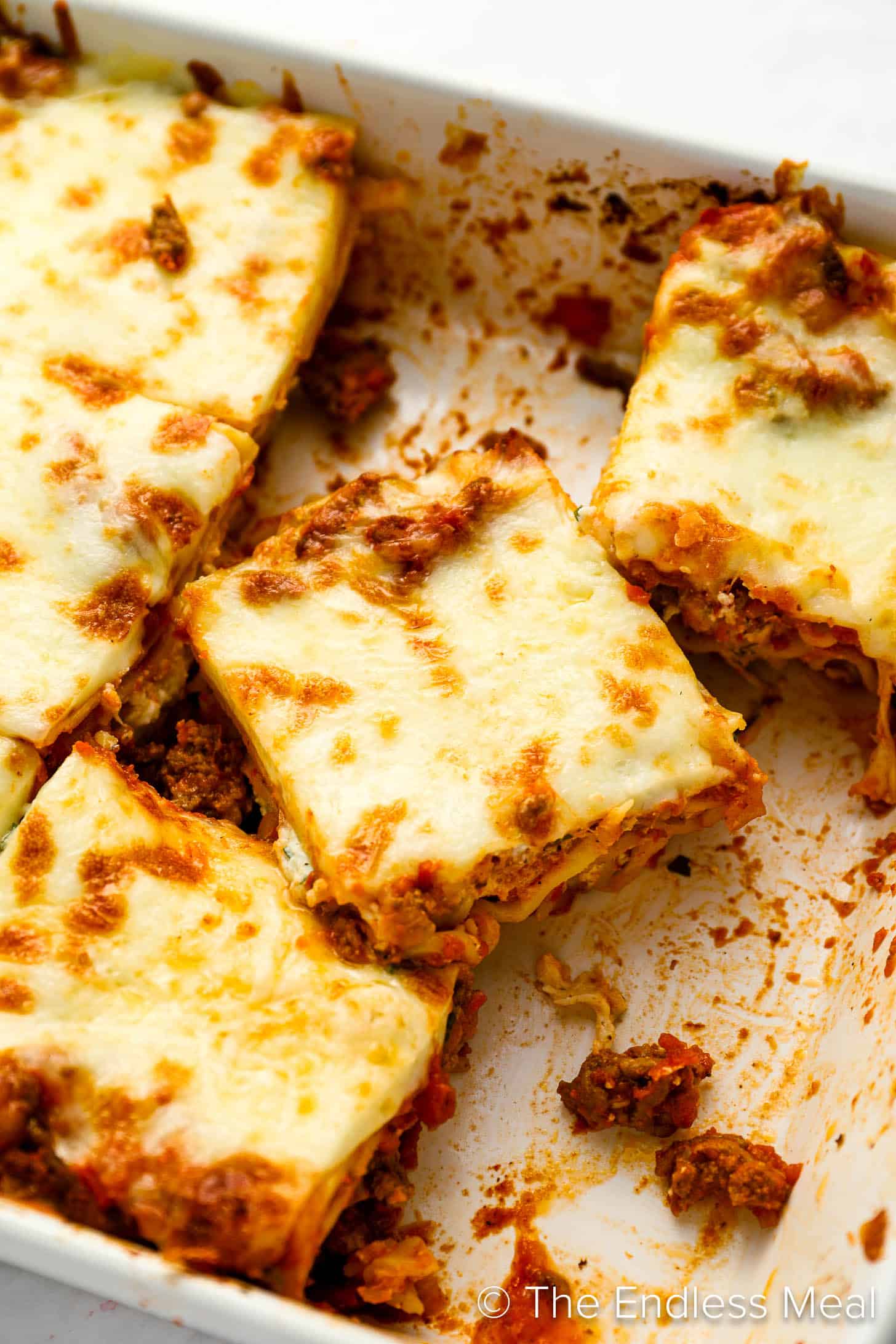 Slices of this Easy Lasagna Recipe in a a baking dish