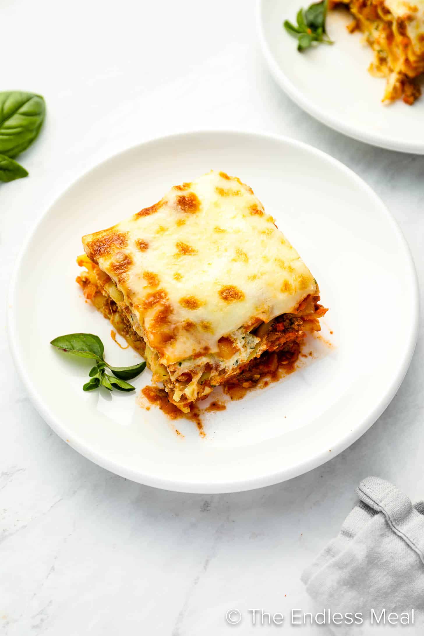 A slice of this easy lasagna recipe on a white dinner plate. 