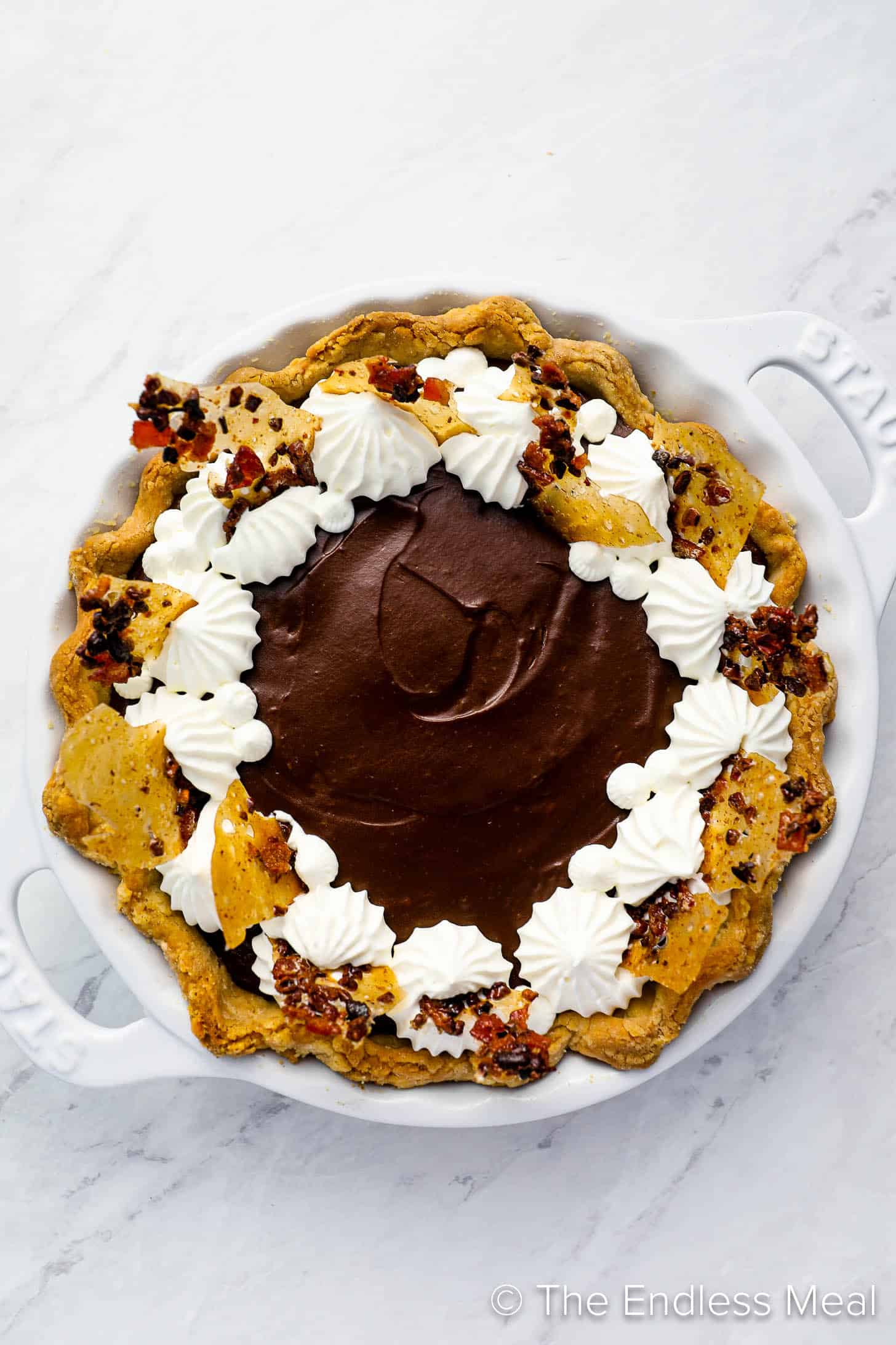 Chocolate Pie decorated with praline and whipped cream