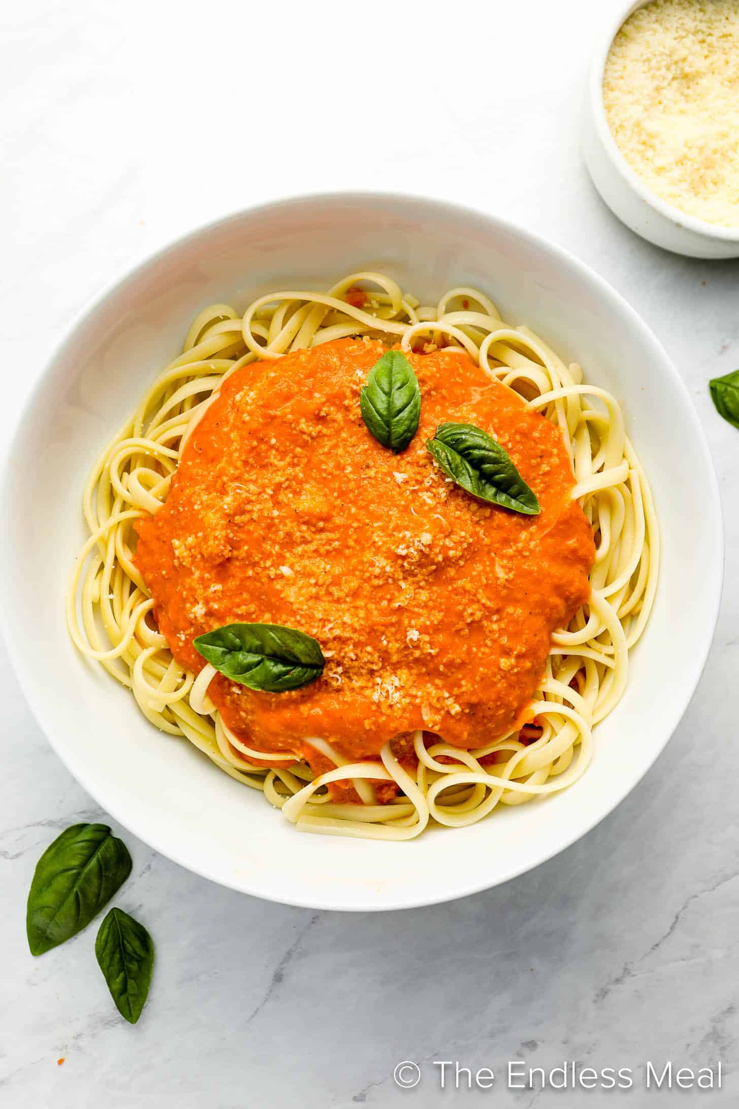 Tomato Cream Sauce over pasta in a dinner bowl.