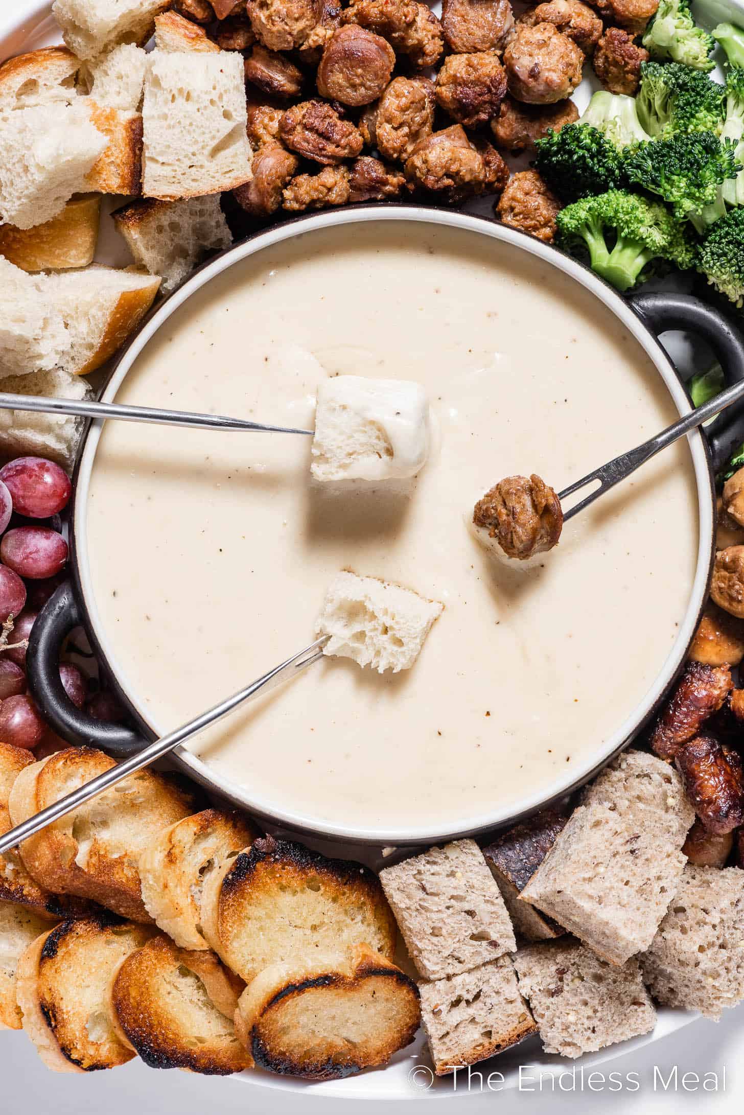 Gruyere Cheese Fondue with fondue forks dipping into it.