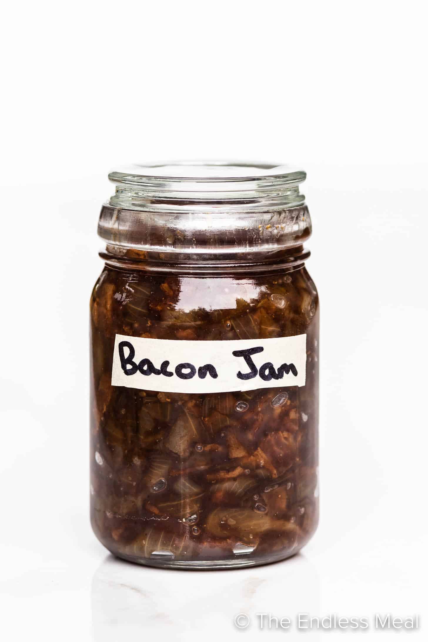 Bacon Jam in a glass jar with a label.