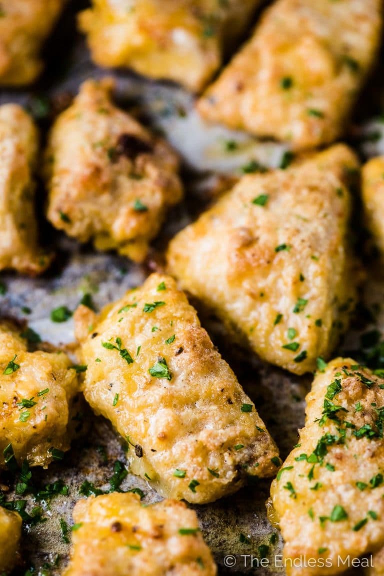 A close up of crispy baked chicken nuggets. 