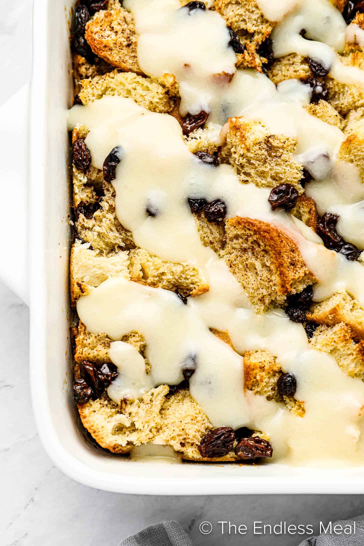 A close up of easy bread pudding with bourbon cream sauce.