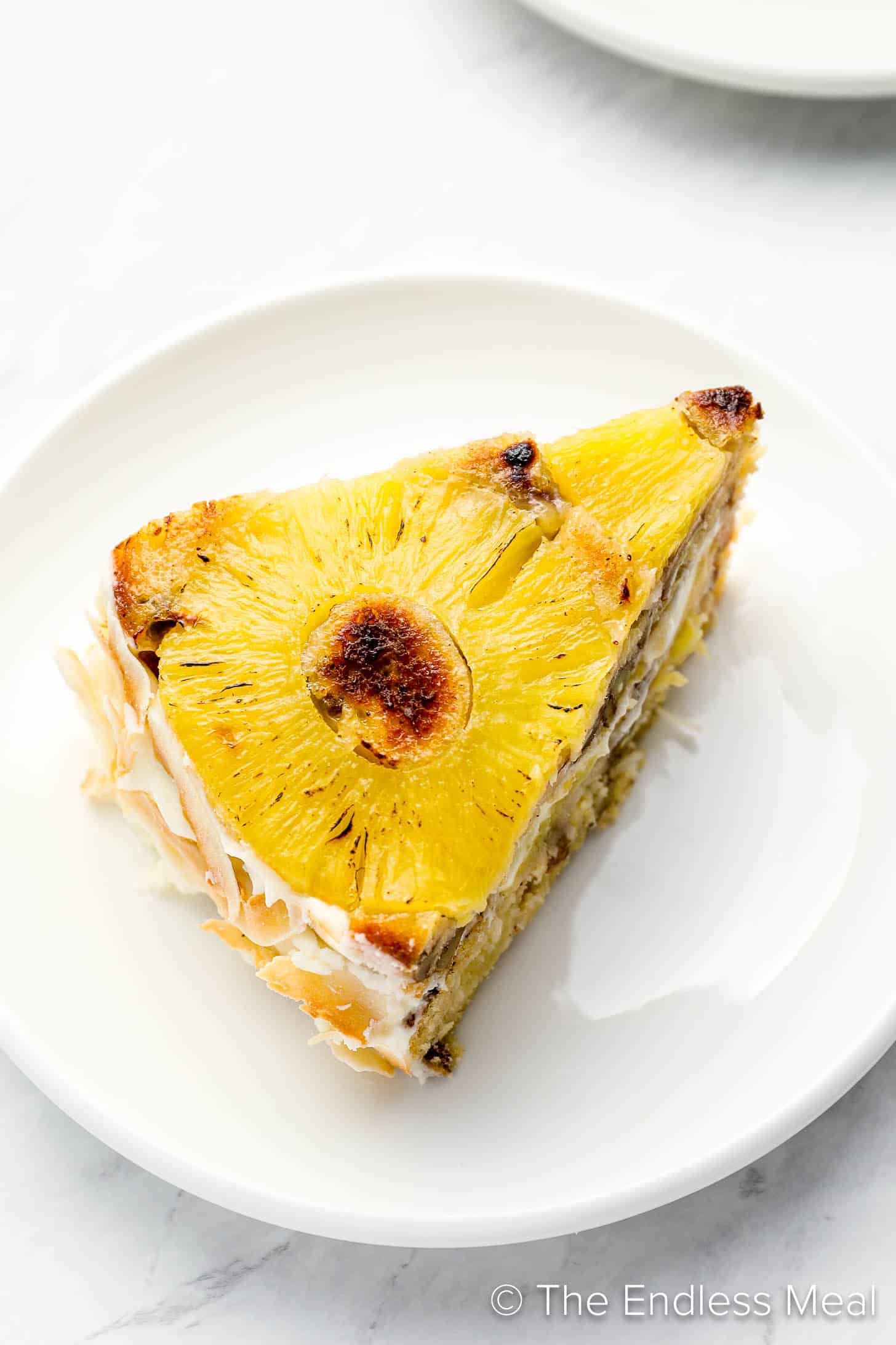 A slice of Pineapple Coconut Upside Down Cake on a plate