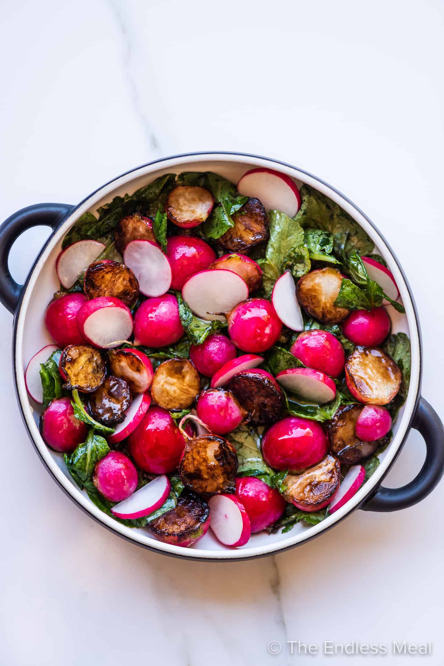 sauteed radishes and radish greens in a serving bowl.