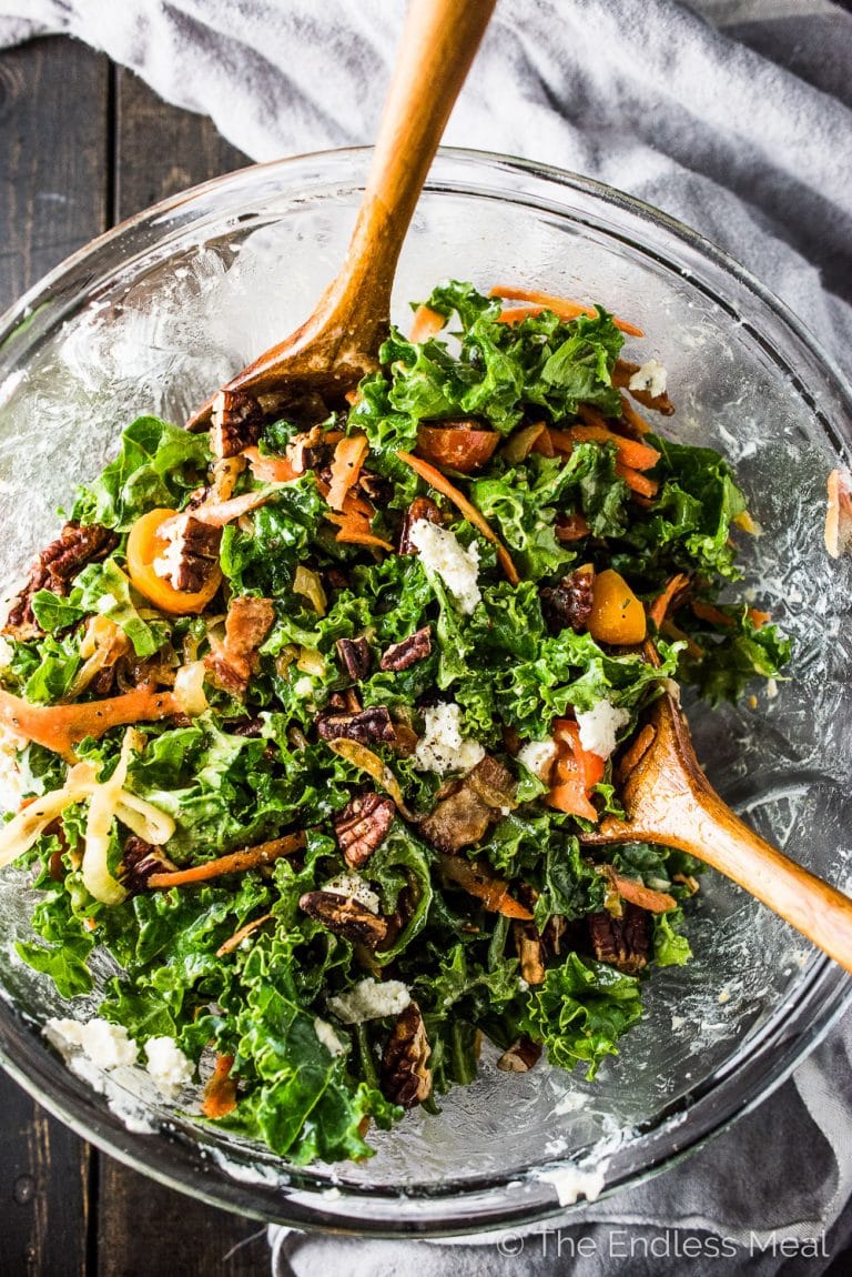 Of all the salads I've tried, I think this is The Best Kale Salad. It's loaded with crispy bacon, toasted pecans, sweet tomatoes, and creamy avocado and Boursin cheese. There are also some caramelized onions in here, which might sound a bit strange, but taste incredible. You will LOVE it! | theendlessmeal.com | #kale #kalesalad #salad #healthyrecipes #saladrecipes 