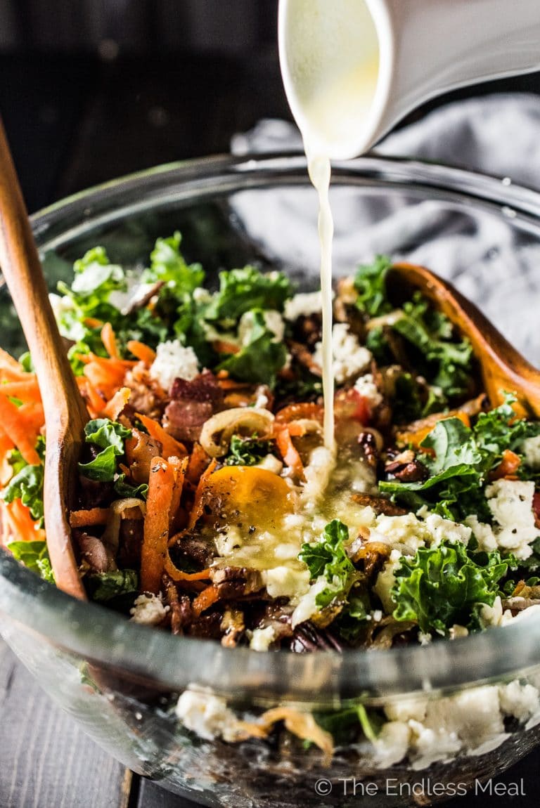 Of all the salads I've tried, I think this is The Best Kale Salad. It's loaded with crispy bacon, toasted pecans, sweet tomatoes, and creamy avocado and Boursin cheese. There are also some caramelized onions in here, which might sound a bit strange, but taste incredible. You will LOVE it! | theendlessmeal.com | #kale #kalesalad #salad #healthyrecipes #saladrecipes 