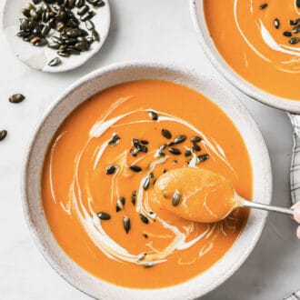 a spoon in a bowl of spicy butternut squash soup