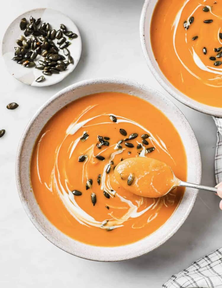 a spoon in a bowl of spicy butternut squash soup