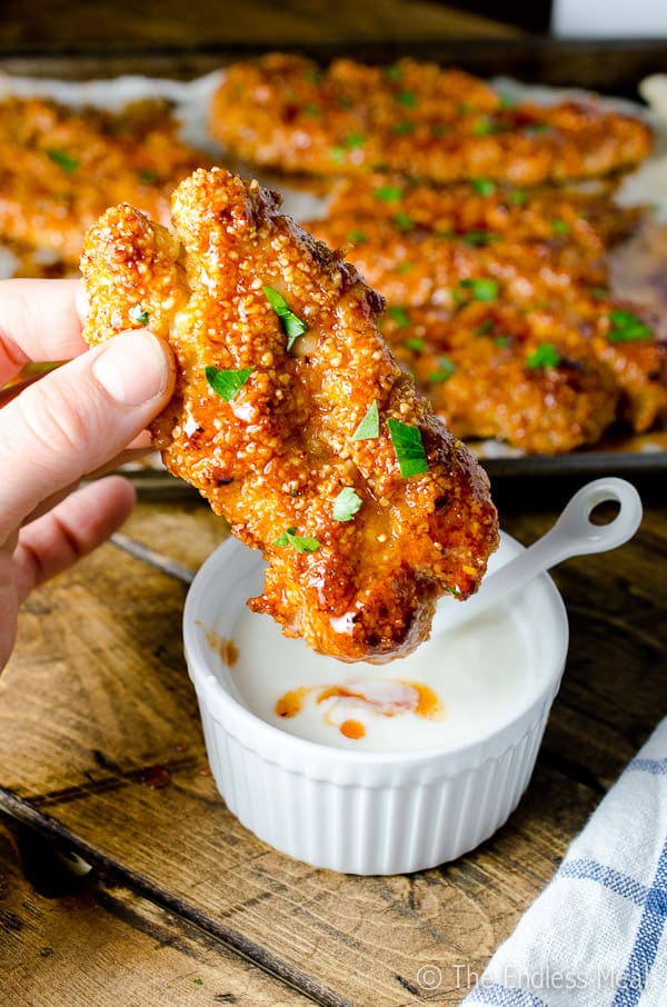 These delicious Baked Paleo Chicken Tenders are sticky and sweet with just the right amount of spice. They're a quick and easy, healthy dinner recipe your whole family will LOVE! | theendlessmeal.com | #chickenfingers #paleo #paleochicken #familyrecipes #chickenrecipes #healthyrecipes