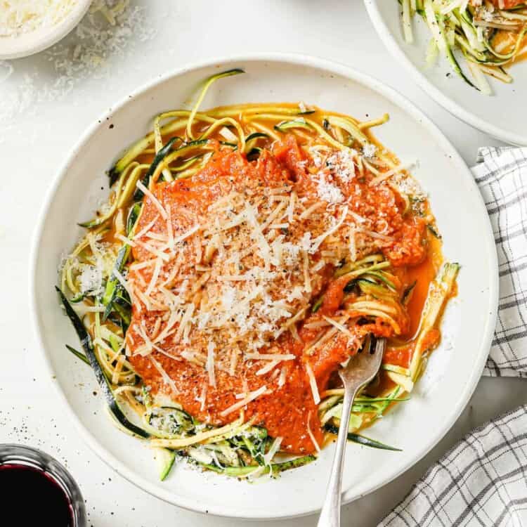 looking down on zucchini spaghetti with tomato sauce in a bowl