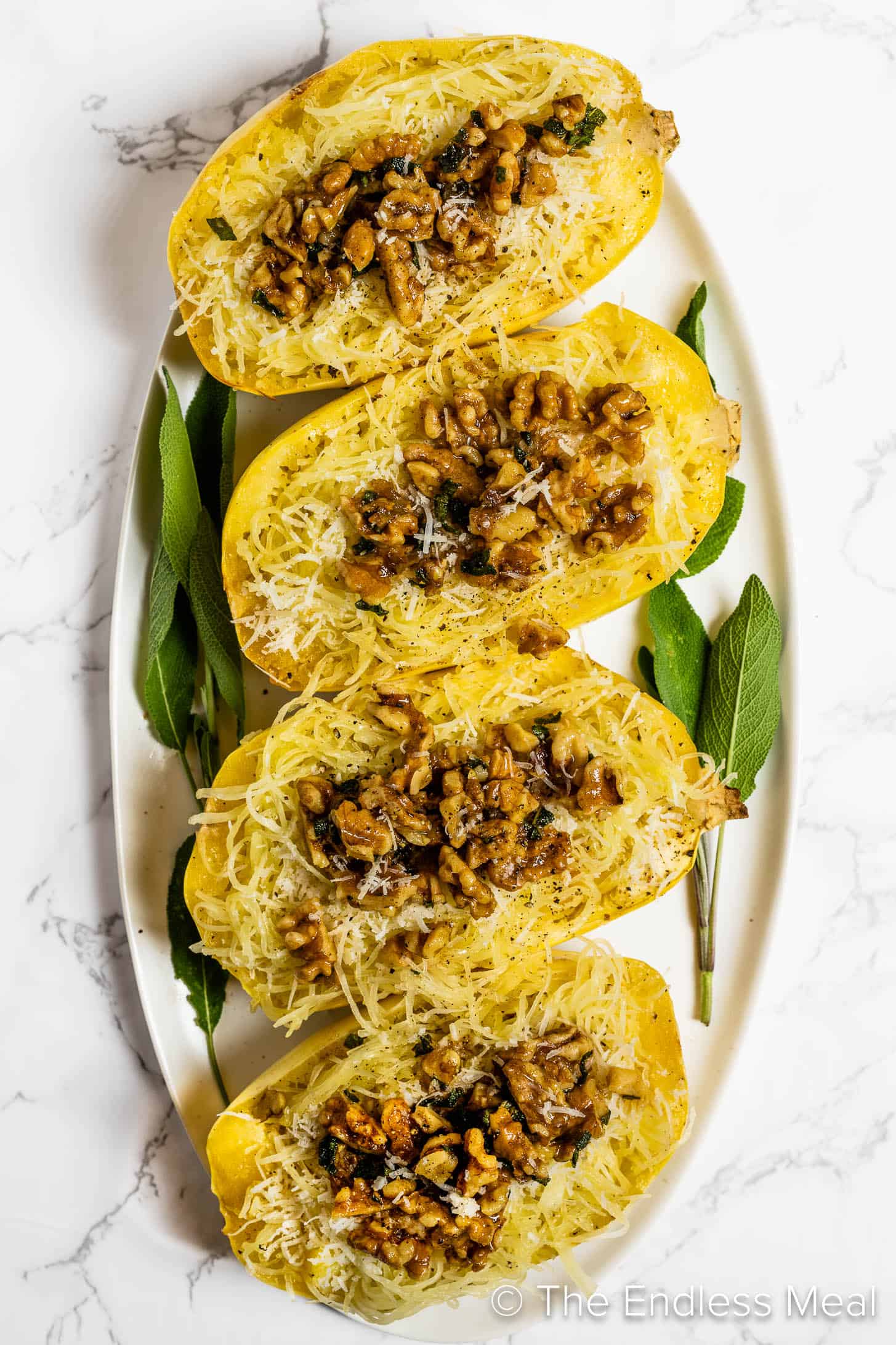 Four Brown Butter Sage Spaghetti Squash with walnuts on a serving platter