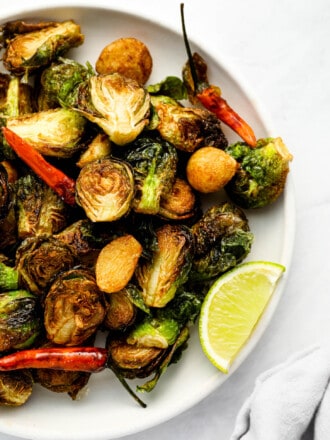 A close up of Fried Brussels Sprouts on a serving plate