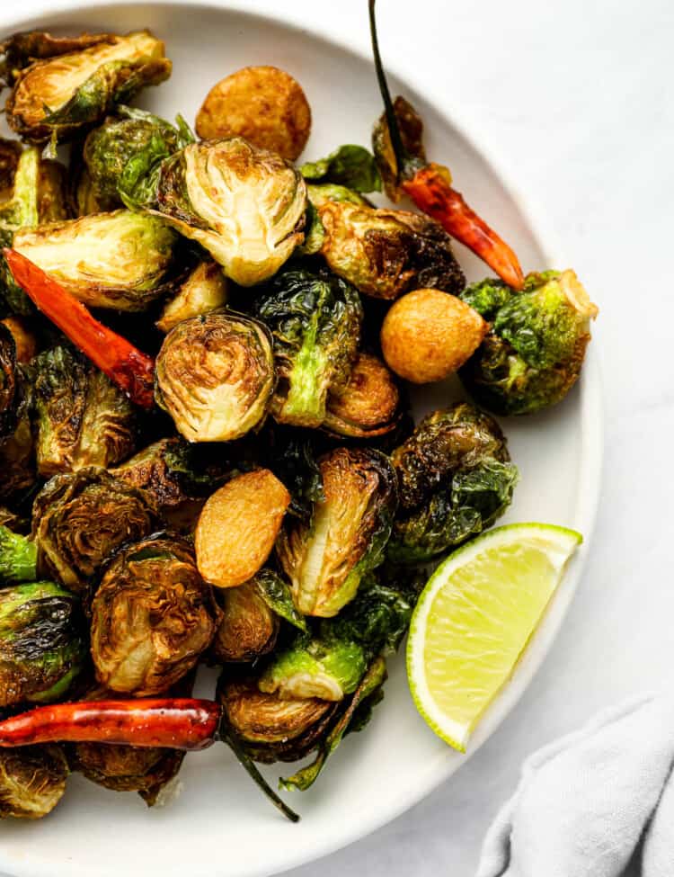 A close up of Fried Brussels Sprouts on a serving plate