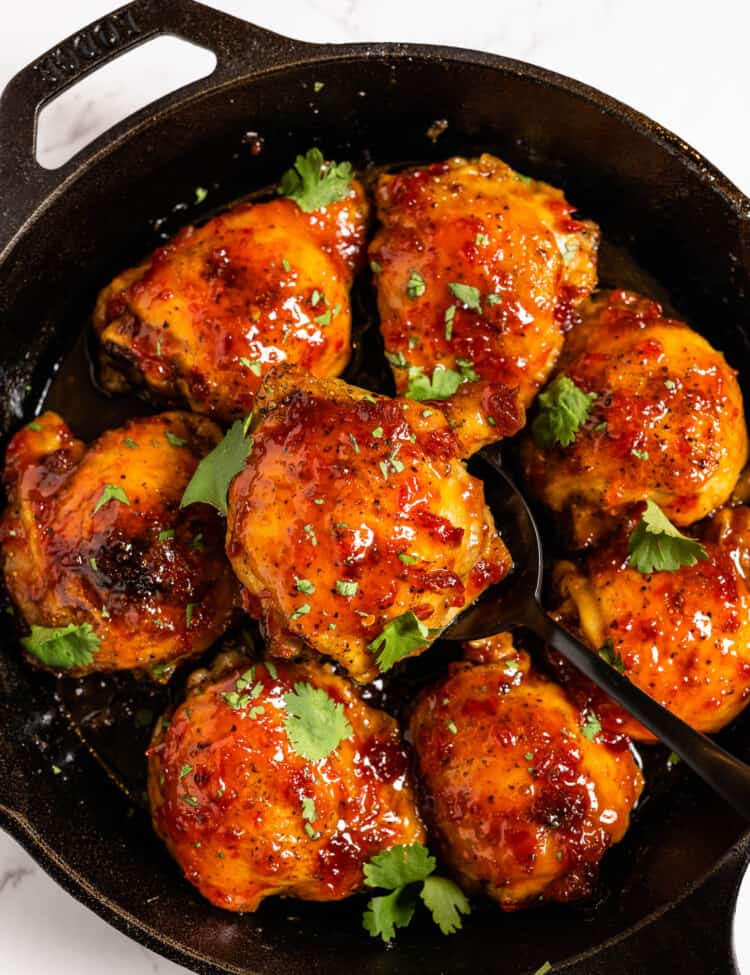 Harissa Honey Chicken in a cast iron pan.