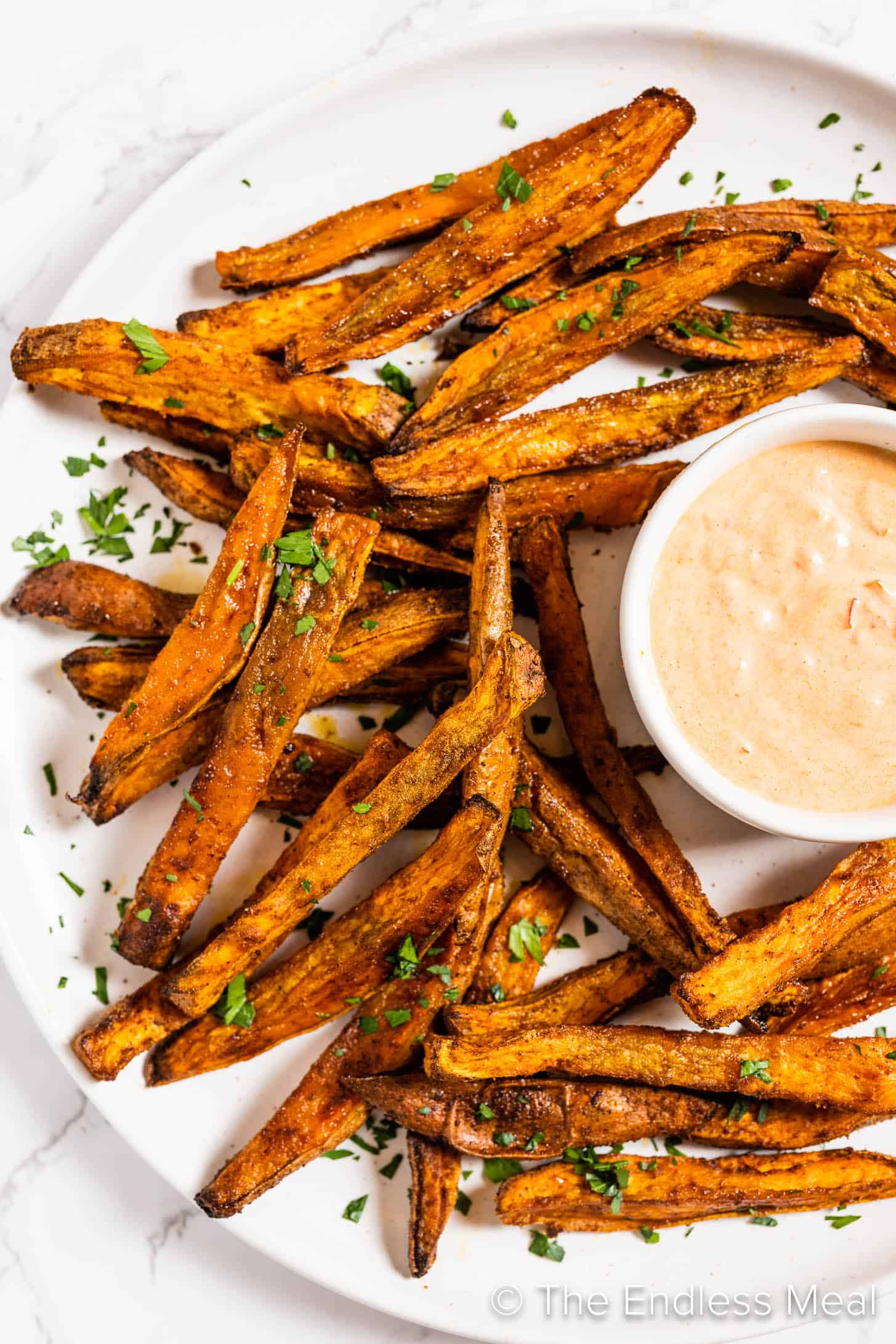 Spicy Sweet Potato Fries on a plate with harissa mayo