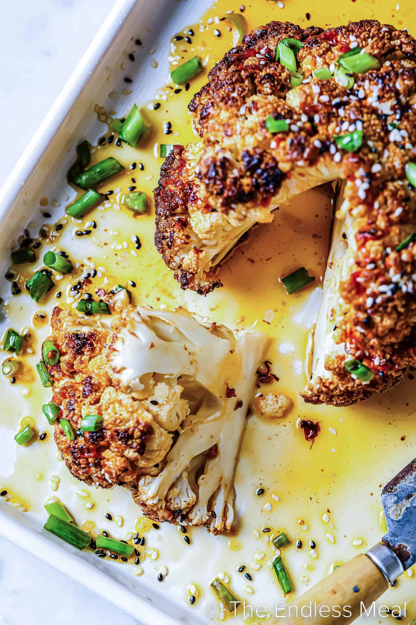 looking down on a head of Whole Roasted Cauliflower with a slice cut out.