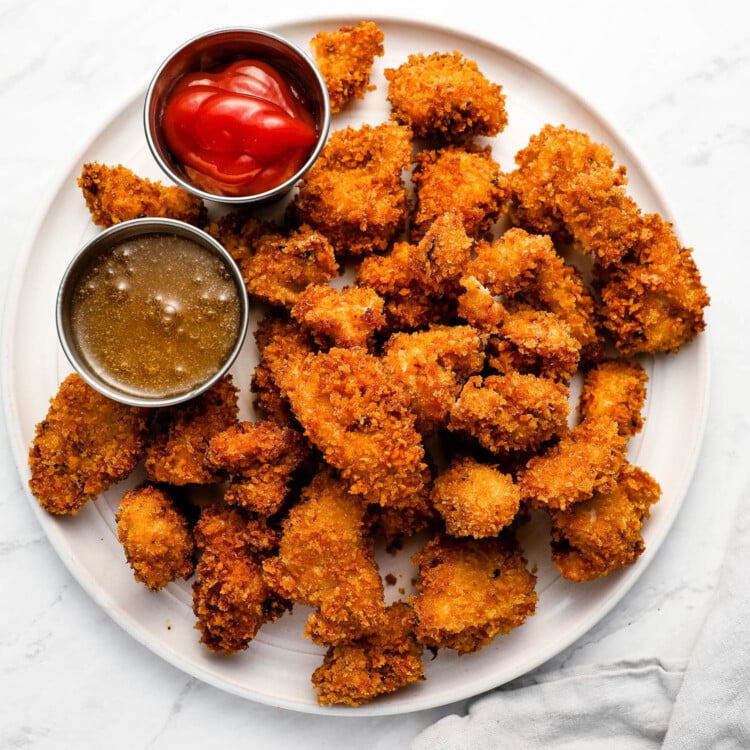 Popcorn Chicken on a dinner plate with dips