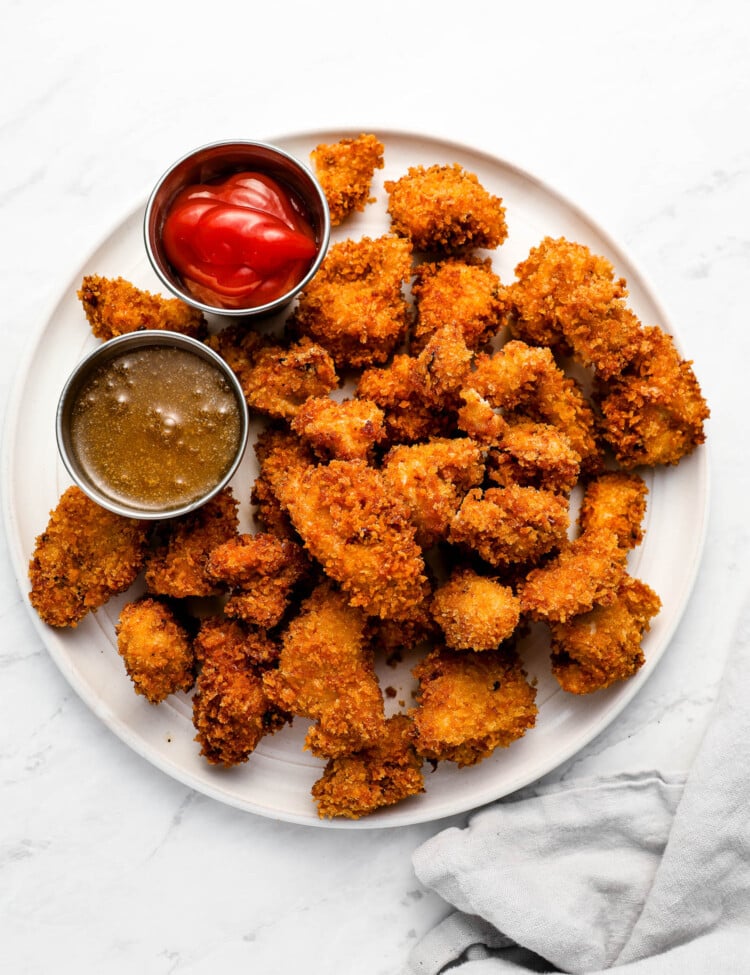 Popcorn Chicken on a dinner plate with dips