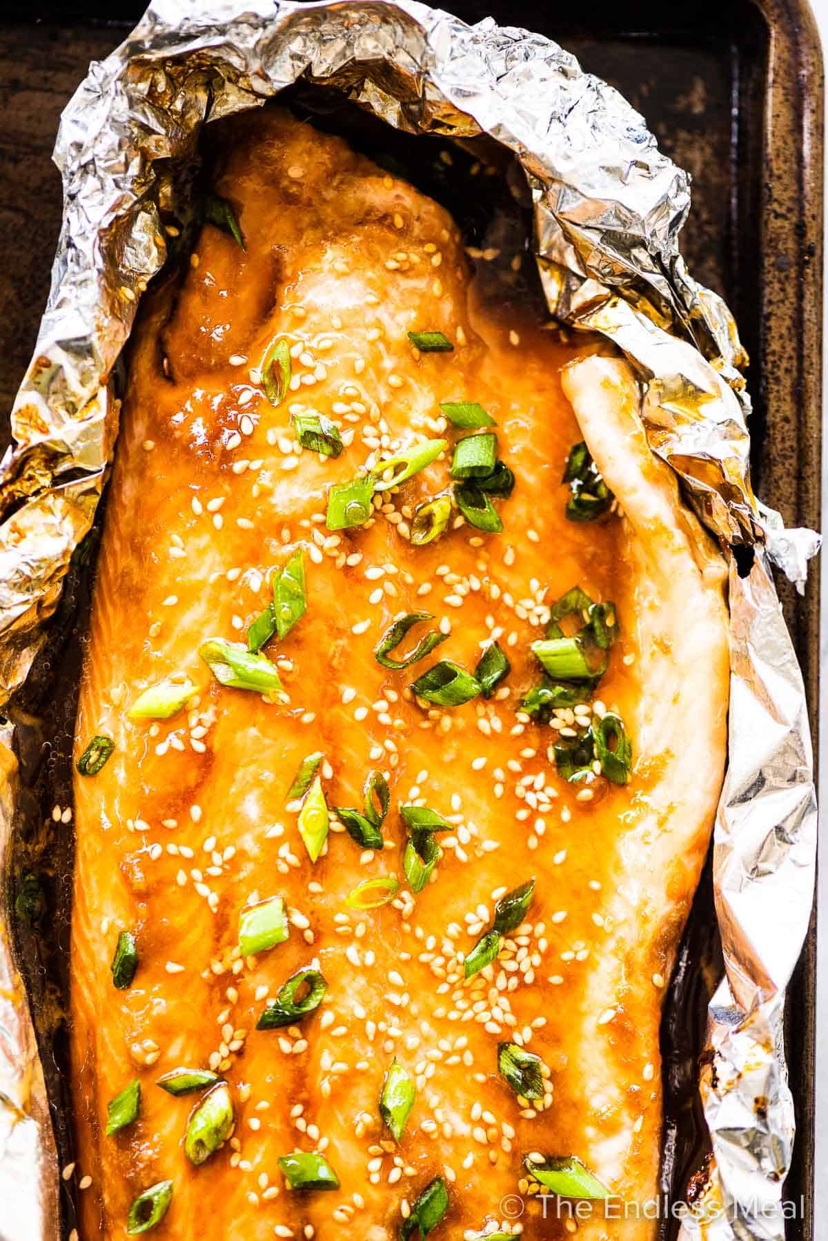 Asian salmon in foil on a baking sheet.