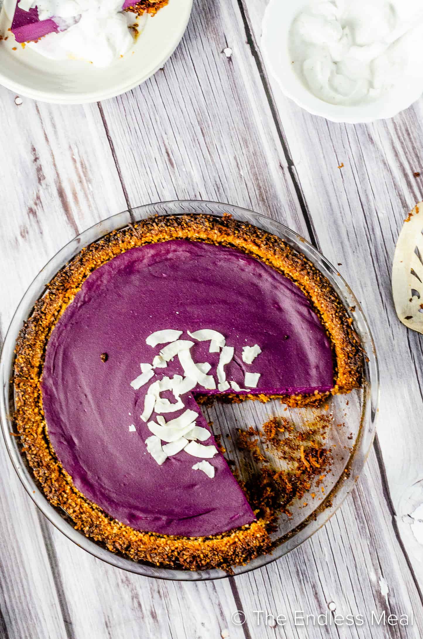Vegan Purple Sweet Potato Pie with a slice beside it on a dessert plate.