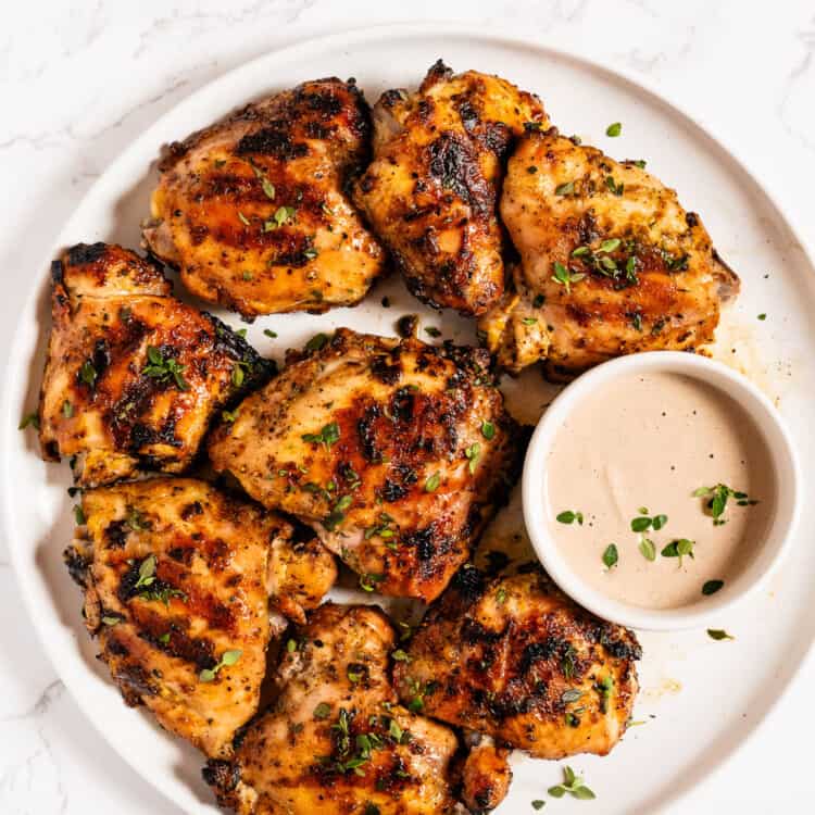 Grilled Mustard Chicken on a plate with a side of walnut mustard sauce.