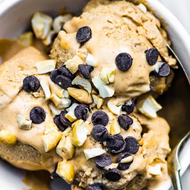 A spoon taking a scoop of banana peanut butter ice cream.