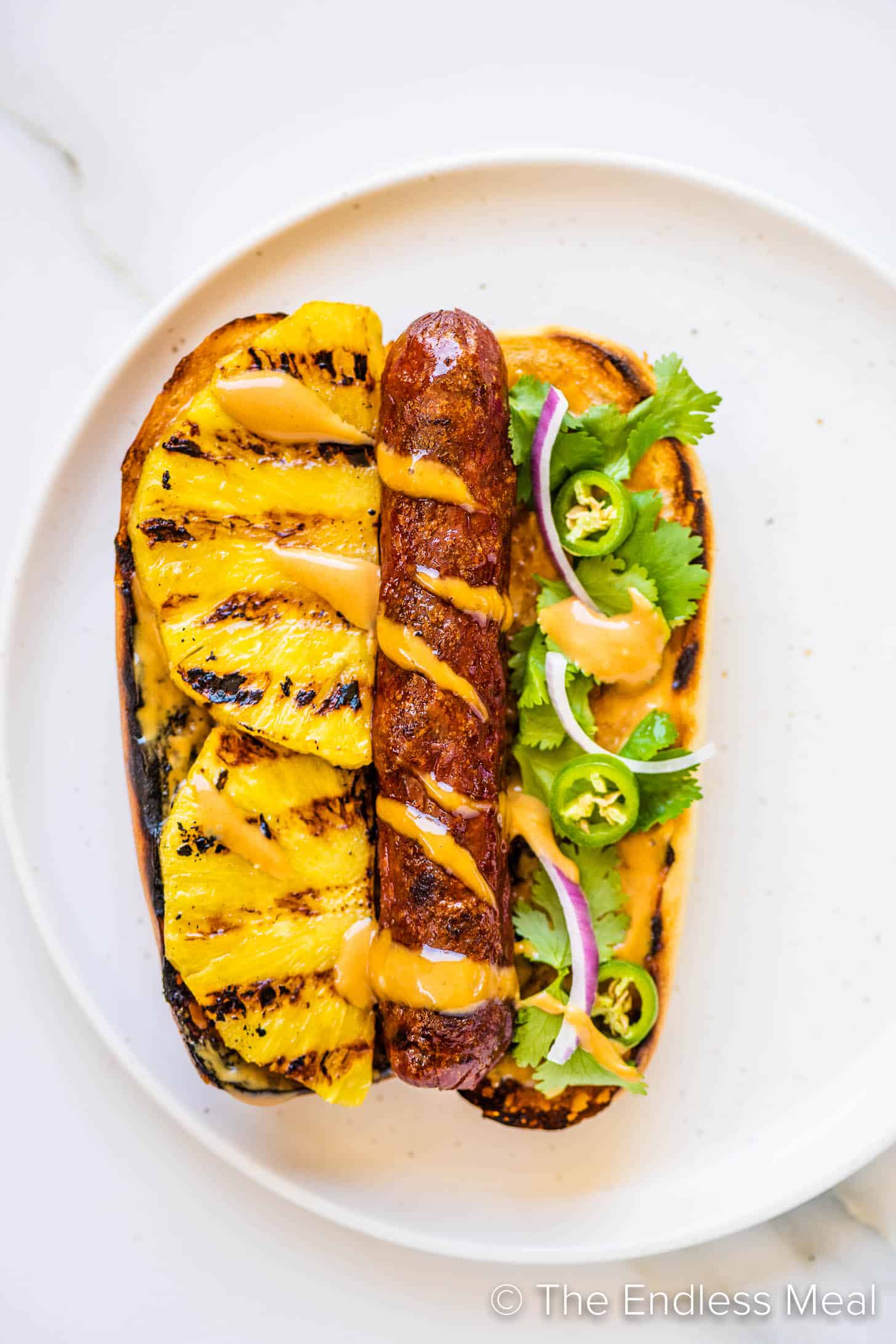 a Hawaiian Hot Dog on a plate with pineapple