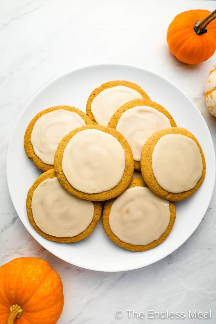 A plate of Pumpkin Sugar Cookies with ginger frosting