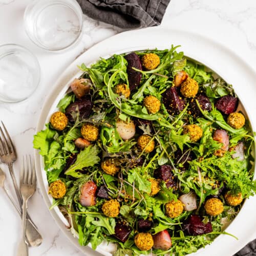 Roasted Beet Salad with Goat Cheese and Pistachios on a dinner table