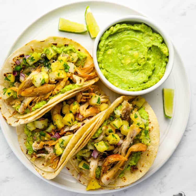 Rotisserie Chicken Tacos on a dinner plate with guacamole