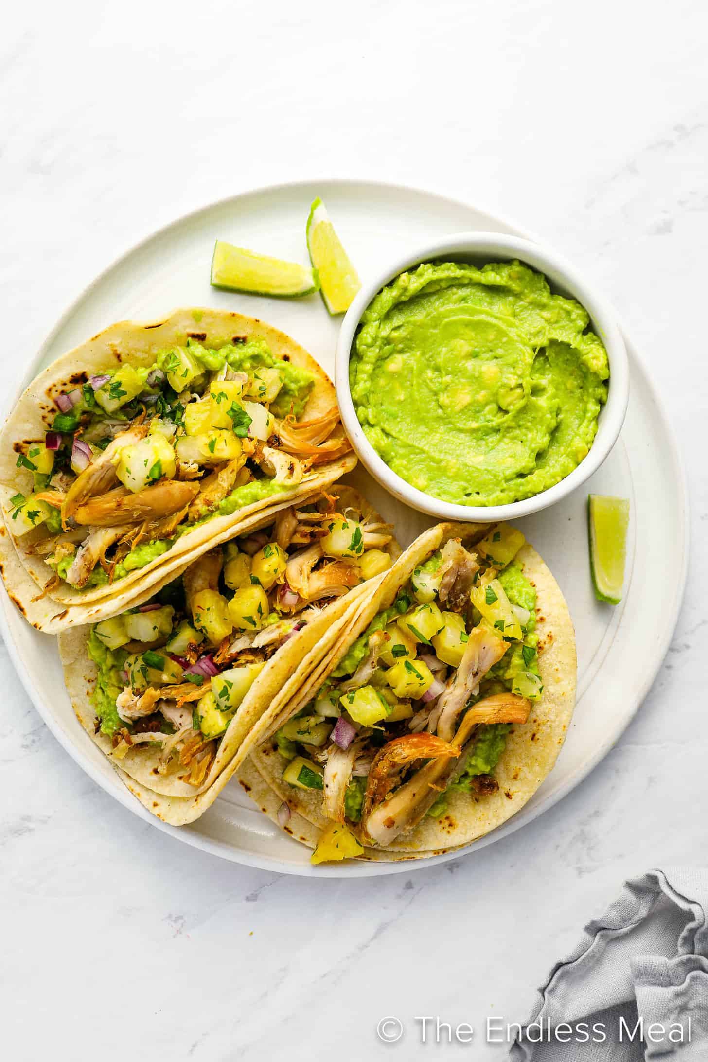 Rotisserie Chicken Tacos on a dinner plate with guacamole