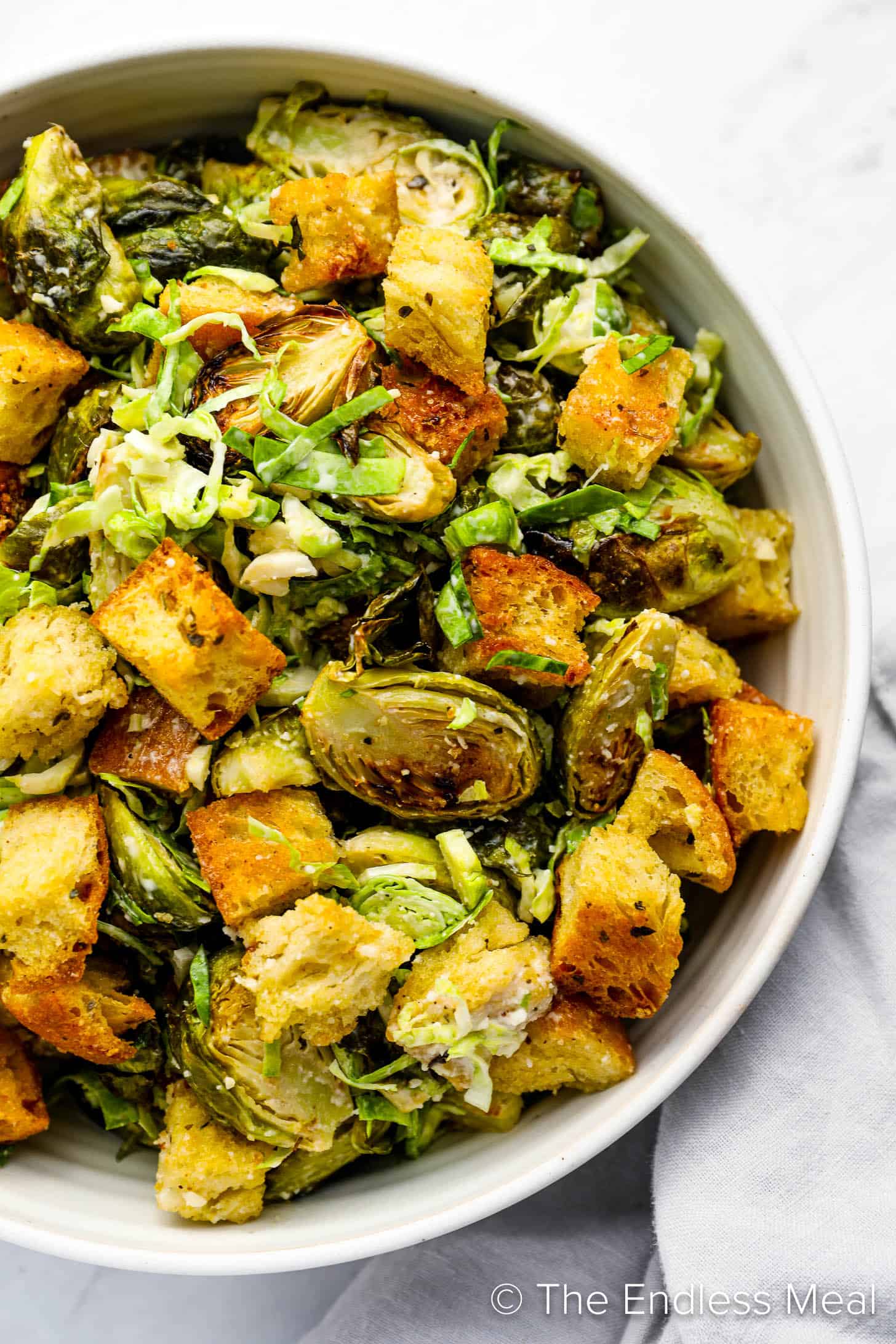 A close up of Brussels Sprouts Caesar Salad in a bowl